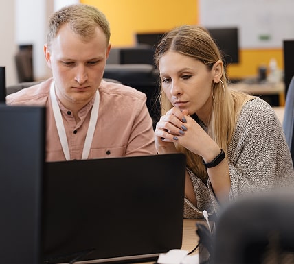 Two IT professionals collaborating on a technical issue